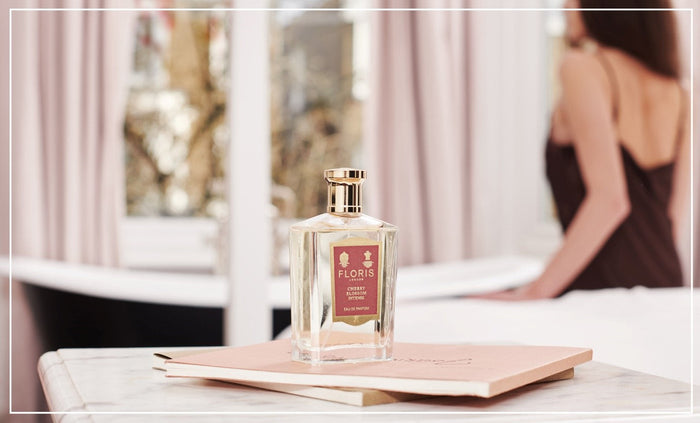 Cherry Blossom Intense Eau de Parfum on a marble side with lady in background