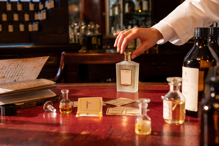 a hand on a perfume bottle 