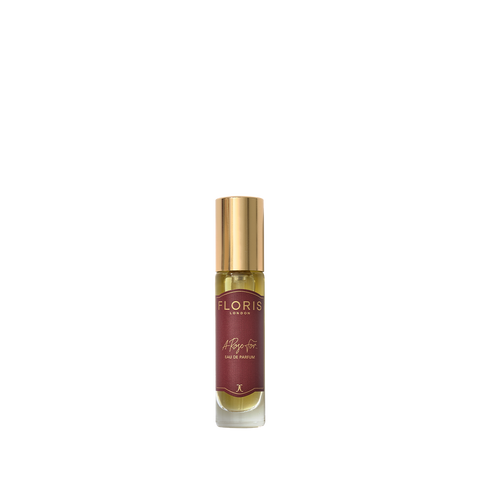 This small bottle of Floris London "A Rose For..." perfume has a gold cap and maroon label, making it a unique gift against a white backdrop.