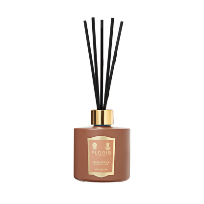 Floris London Cinnamon & Tangerine Reed Diffuser features a brown bottle with black reeds and gold label, offering a rich, room-filling fragrance.