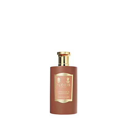 A bottle of Floris London Cinnamon & Tangerine Room Fragrance with a gold cap and label, featuring a rich spice blend of amber sandalwood.
