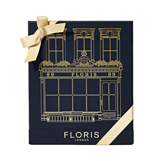 Navy blue Floris London UK Sweet Lux | Honey Oud Duo gift box with gold illustration, a gold bow, and luxurious Honey Oud Eau de Parfum inside.