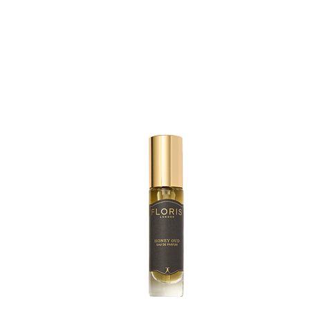 A bottle of Floris London's Honey Oud Eau de Parfum features a gold cap, dark label, and is enriched with notes of English honey and oud oil.