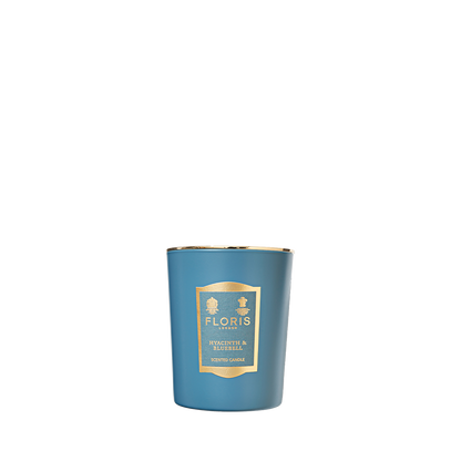 Floris London's "Hyacinth & Bluebell" 175g candle, with gold accents, delivers a refreshing green floral fragrance for a richly scented atmosphere.