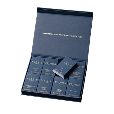 A blue Floris London UK Sample Set box contains eight neatly arranged 2ml fragrance bottles.