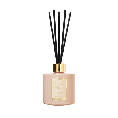 Elegant Floris London diffuser with a gold label and black reeds, infused with rich sandalwood and patchouli.