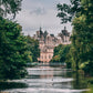 A grand historic building rises by a pond and trees as Floris London’s Mulberry Fig - Eau de Parfum scents the cloudy, duck-dotted air.