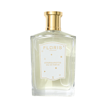 A clear glass bottle of Floris London UK Stephanotis | Limited Edition perfume, with a gold cap, white label, and a delicate floral scent.