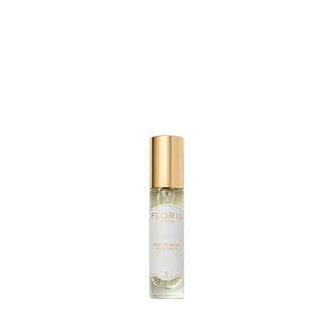 A perfume bottle with a gold cap labeled "White Rose - Eau de Toilette" by Floris London captures the timeless vibrancy of velvet roses, on a white background.