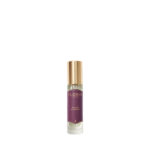 Floris London's Wilde Eau de Parfum features a small spray bottle with a purple label and gold cap, capturing Oscar Wilde-inspired individuality.
