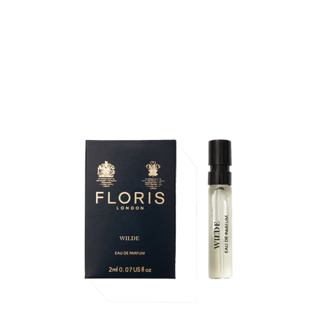 A deep blue box of Floris London Wilde - Eau de Parfum sits beside a small clear spray vial, representing freedom and individuality.